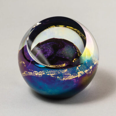 A glass ball with a purple and blue design.