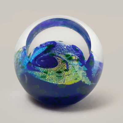 A glass ball with a map of the world inside it.