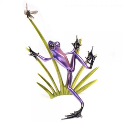A purple frog with long legs and a green plant.