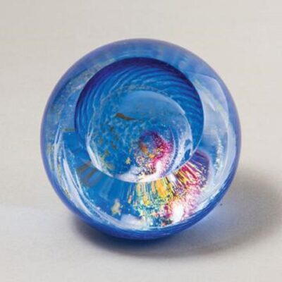 A blue bowl with swirling designs on it.
