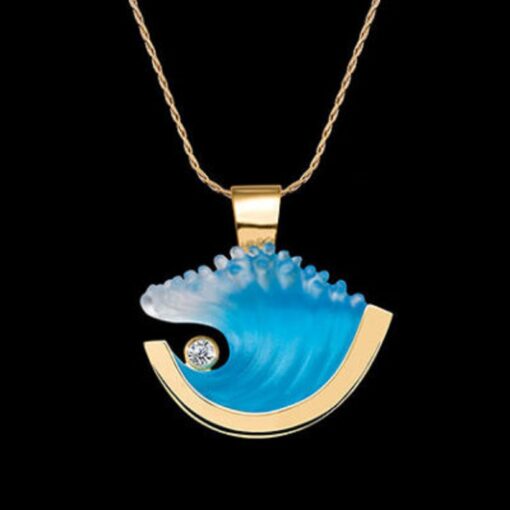 A gold necklace with a blue wave and diamond.
