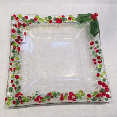 A square glass plate with red and green confetti.