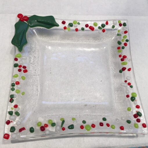 A glass plate with a bow and candy canes on it.