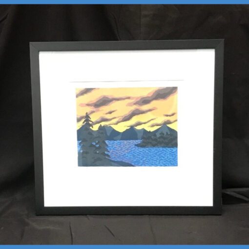 A painting of mountains and water in a black frame.