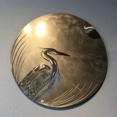 A metal plate with an image of a bird on it.