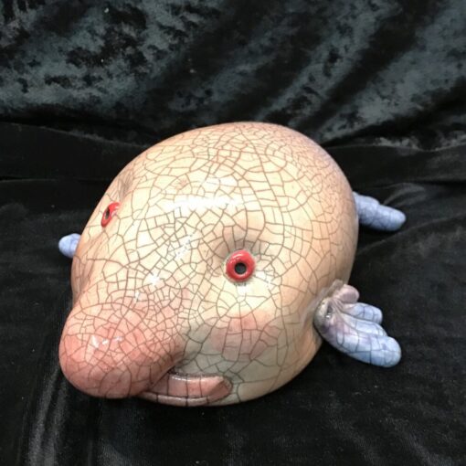 A stuffed animal of an animal with red eyes.