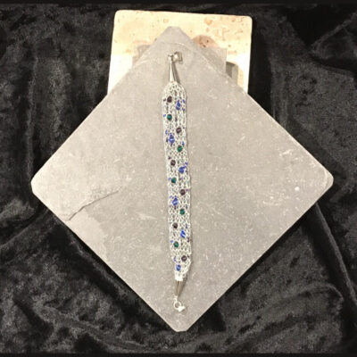 A long glass bead necklace on top of a card.
