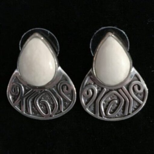 A pair of silver earrings with white stones.