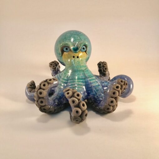A blue octopus with brown spots on it's legs.