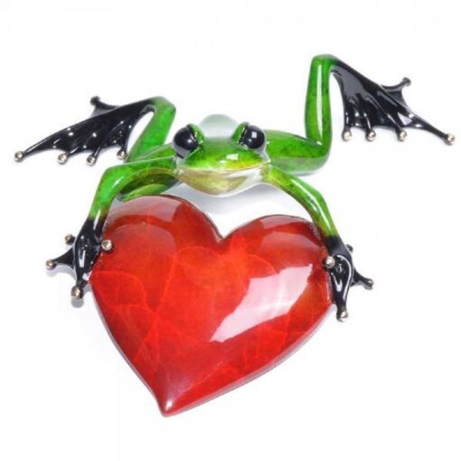 A frog with wings and holding a heart.