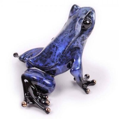 A blue frog sitting on top of a white surface.