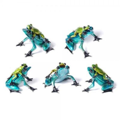 A group of five frogs that are sitting on the ground.
