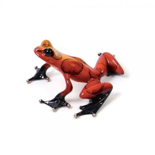 A red frog with black legs and yellow head.