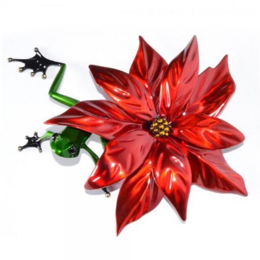 A red flower with green leaves and a frog on it.