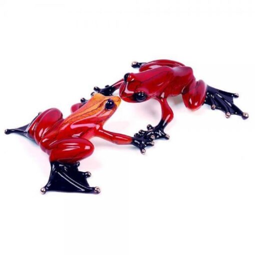 A red frog is sitting on top of another red frog.