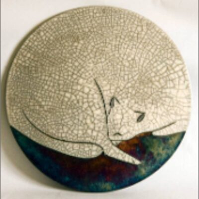 A round ceramic plate with a picture of an animal on it.