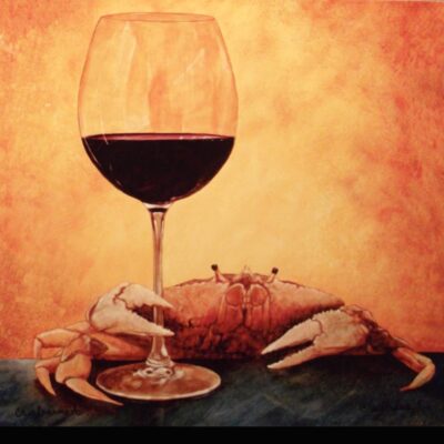 A crab and a glass of wine on the table