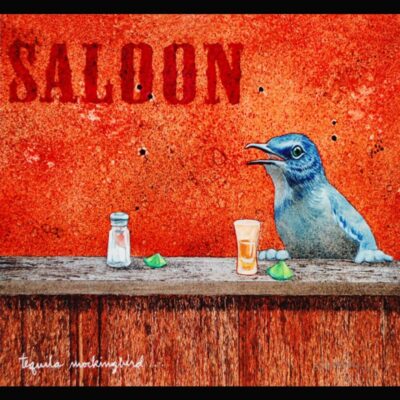 A blue bird sitting on top of a wooden table.