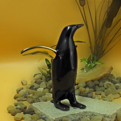 A black penguin statue with a gold beak.
