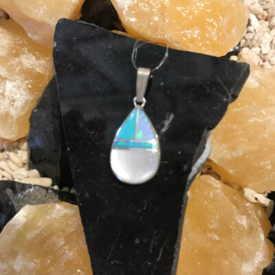 A necklace that is sitting on some rocks