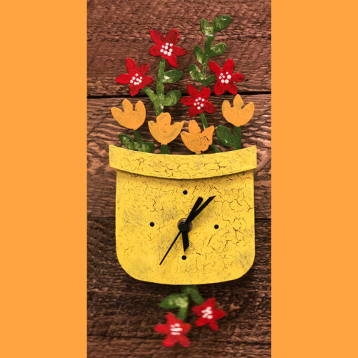 A yellow clock with flowers in it