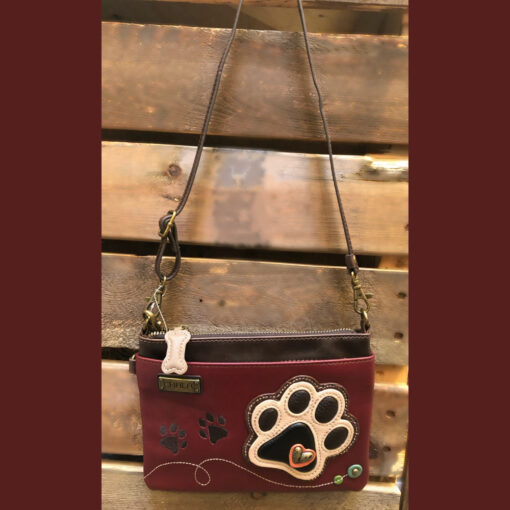 A red purse with a dog paw print on it.