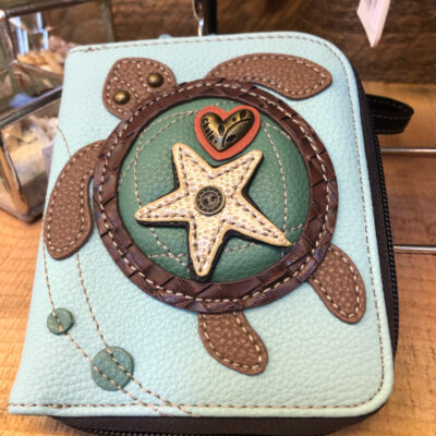 A blue wallet with a sea turtle and star on it.