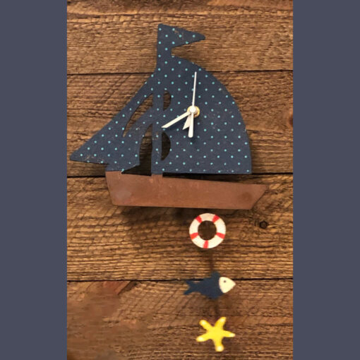 A wooden sailboat clock with a star and a fish.