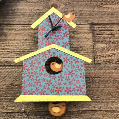A bird house with two birds on it.