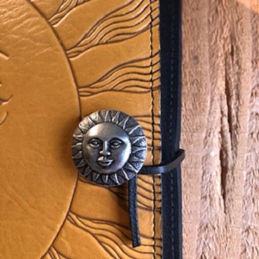 A close up of the sun on a leather book
