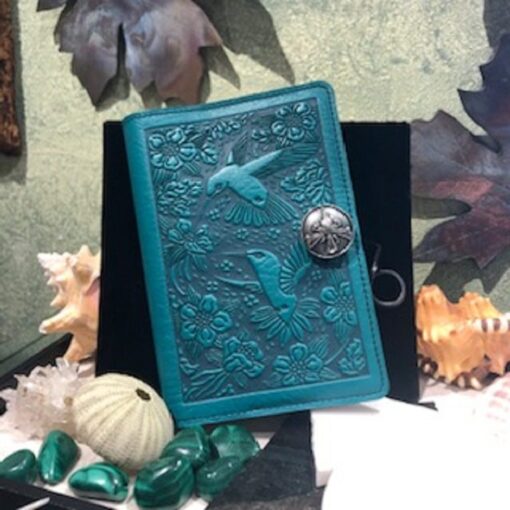 A teal leather book with a bird on it.