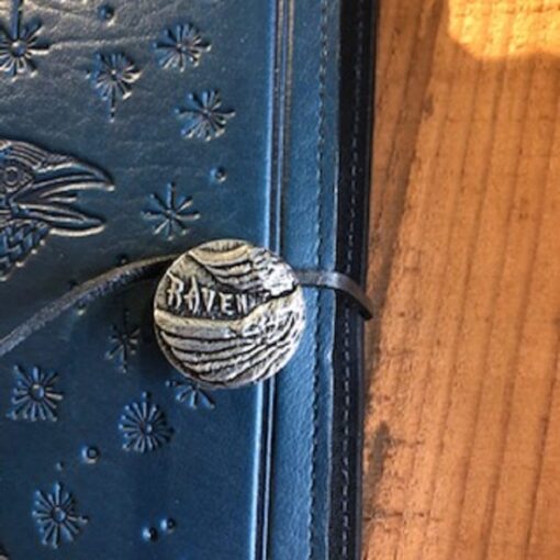 A close up of the door handle on a blue book.
