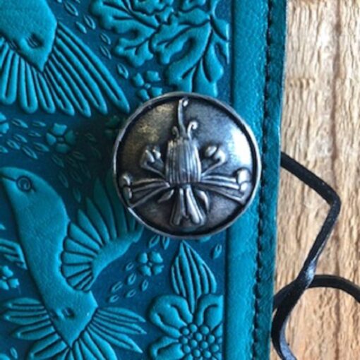 A close up of the door knob on a blue leather book.