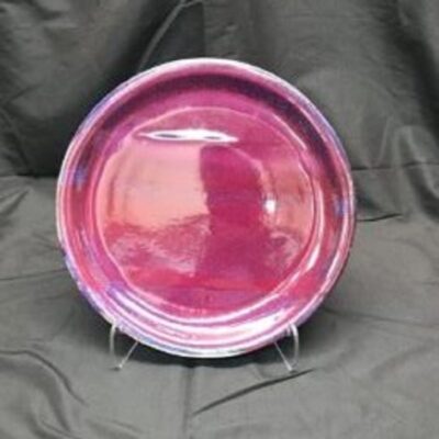 A pink plate sitting on top of a table.