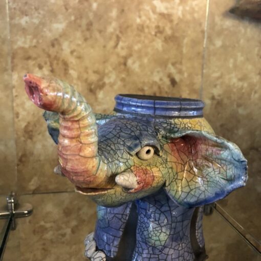 A colorful elephant statue in the bathroom