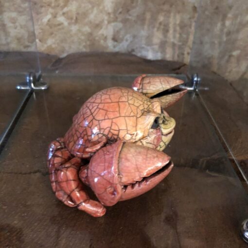 A crab statue sitting on top of a table.