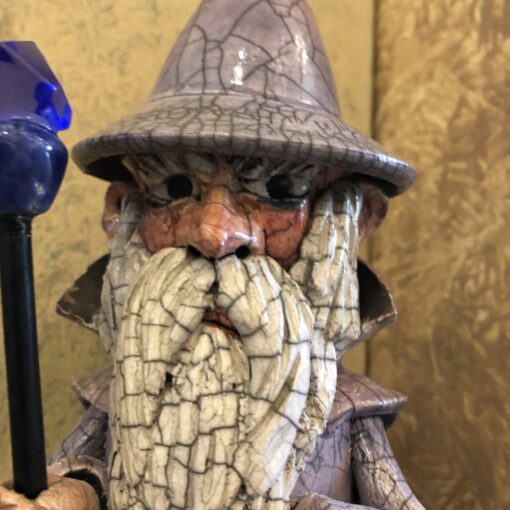 A close up of a figurine with a hat and beard