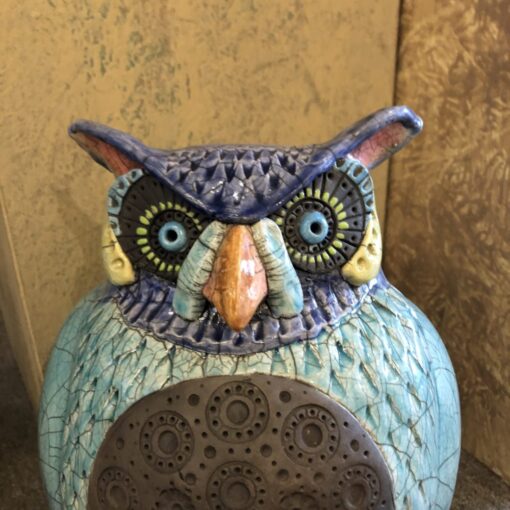 A close up of an owl statue