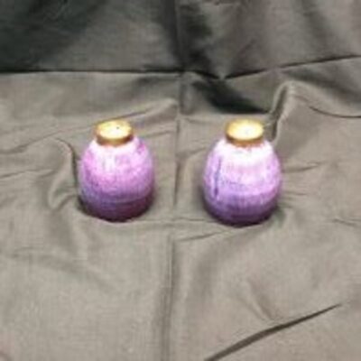 A pair of purple and gold vases sitting on top of a table.