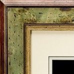 A picture frame with some green paint on it