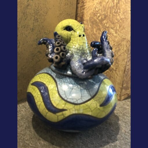 A yellow and blue ceramic sculpture of an octopus.