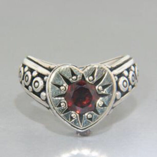 A silver ring with a heart shaped stone.