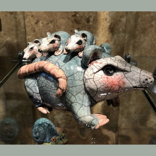 A sculpture of four mice on top of each other.