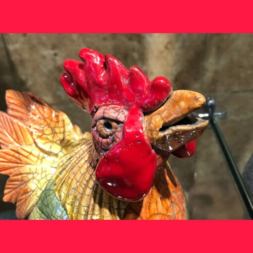 A close up of the head of a rooster statue