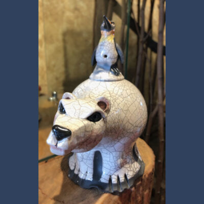 A white bear with bird on top of it.