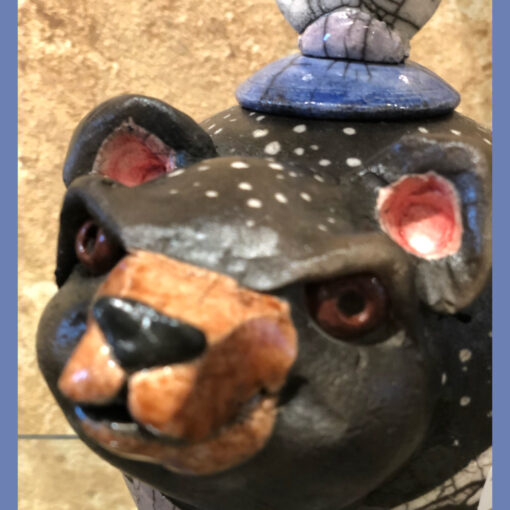 A close up of the head of a bear statue