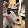 A close up of the head and neck of a cow statue.