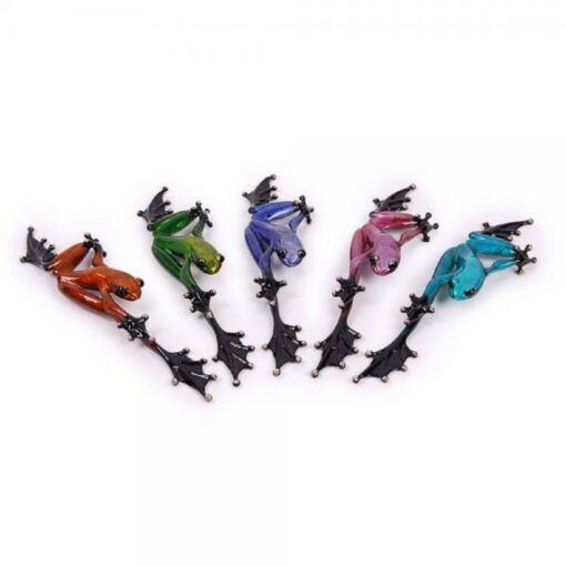 A group of six different colored frogs on sticks.