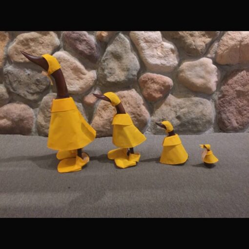 A group of four ducks made out of paper.