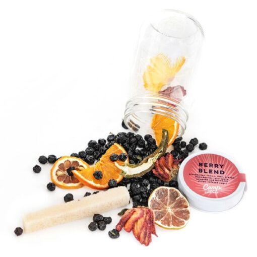 A jar of fruit and other items are on the table.